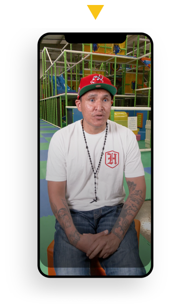 A dad sitting in front of a jungle gym